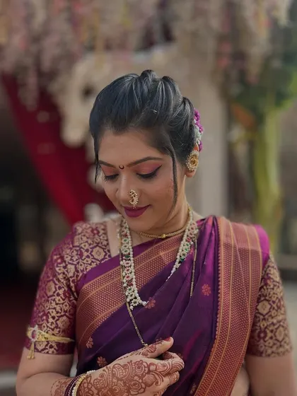 A candid shot showing the bride's intricate henna and the soft, glowing makeup.