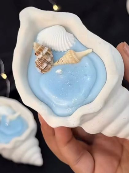 A beautiful example of a concrete shell container filled with blue wax and decorated with smaller shells. This shows how you can combine my molds and decorative elements to create a cohesive piece.