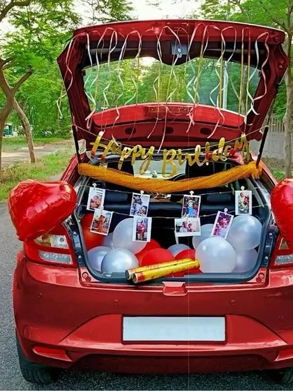 A car boot decoration is a fun and unexpected way to surprise someone. For this birthday, I filled the trunk of this red car with balloons, a 'Happy Birthday' banner, and a string of the couple's personal photos, creating a sweet, personalized celebration on the go.
