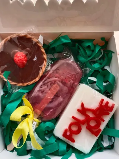 A Taylor Swift-inspired gift box with a 'Folklore' soap, a chocolate tart soap, and a popsicle soap.