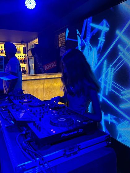 A flashback to a Sunday night gig in Dehradun, with cool blue geometric visuals lighting up the background.