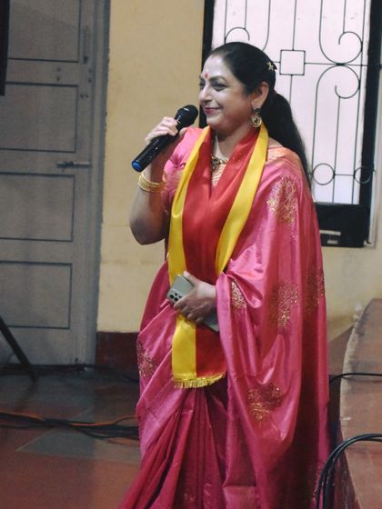 Our guru, Smt. Gayathri Mohan, addresses the audience during the Kannada Rajyotsava event, a celebration of Karnataka's statehood.