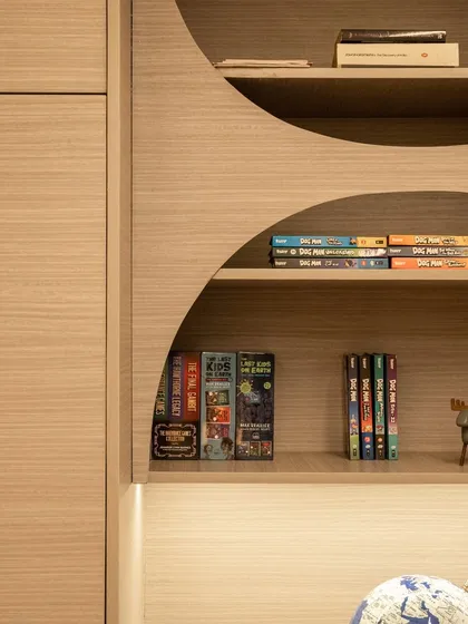 Detail of the curved bookshelf design. This shows our commitment to creating unique, custom furniture that moves beyond simple boxes and adds real character to a room.