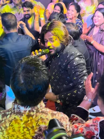 A close-up shot of our frontman Alish Mohan interacting with the crowd, microphone in hand. This personal connection is key to our high-energy shows.