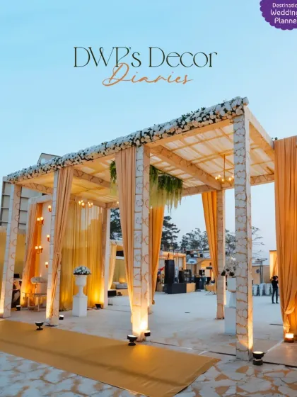 This elegant wedding entrance features golden drapes and warm uplighting, creating a grand and welcoming pathway for the guests.