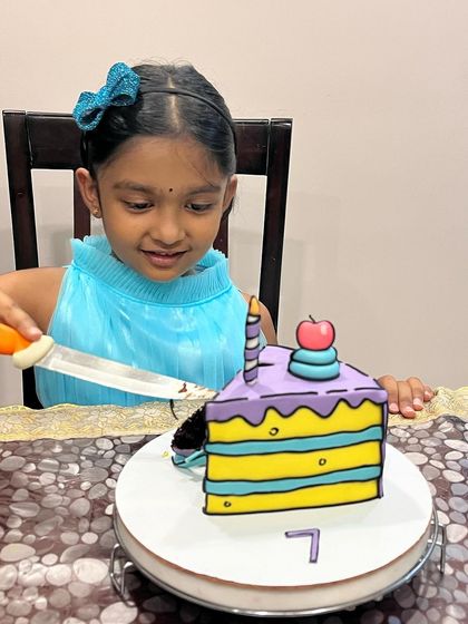 Our daughter's excitement says it all! Here she is, about to cut her very own comic slice cake.