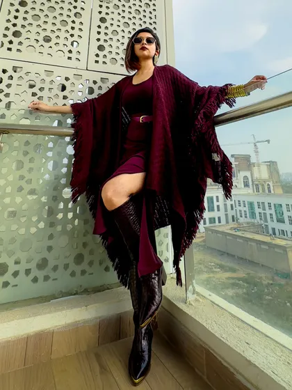 A final dramatic pose in the burgundy outfit. This is a perfect example of an editorial-style look.