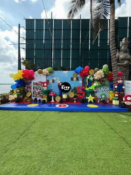 It's-a-me, Mario! I brought the entire Super Mario World to life for this 5th birthday, featuring a massive themed stage with characters, question blocks, coins, and colorful balloons, all set against a beautiful outdoor backdrop.