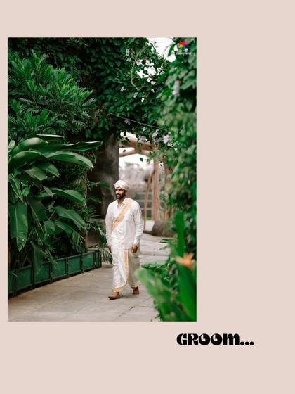 A candid shot of the groom walking through a lush green pathway. This photo captures a natural, relaxed moment during the wedding day.