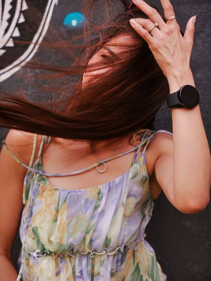 An artistic shot capturing the movement of hair in the wind. It’s a portrait of freedom and uninhibited joy, focusing on feeling rather than a clear view of the face.