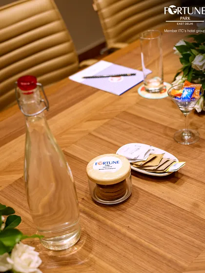 Every element in my boardroom is chosen to support a productive meeting. This view shows the thoughtful placement of refreshments and stationery, part of the all-inclusive service I offer for business gatherings.