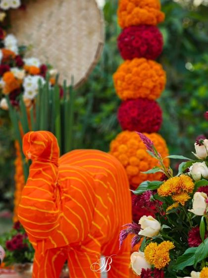 A playful elephant crafted from bright orange striped fabric, another example of our "scrap to sculpture" philosophy. These custom pieces add immense personality to the decor.