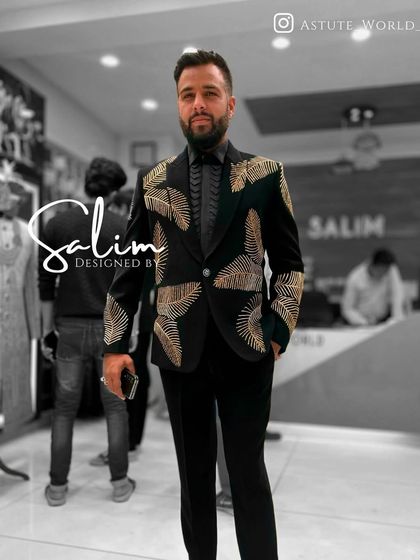 A client in a black velvet tuxedo with gold embroidered patterns. The design is inspired by natural forms, giving it an organic yet luxurious feel.