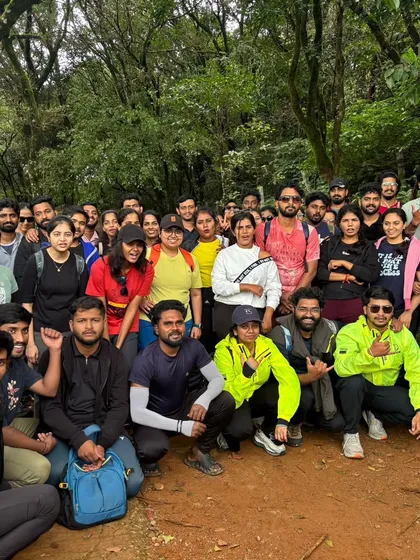 A packed group photo on a forest trail. Our treks attract a lively crowd of nature lovers and adventurers from all over.