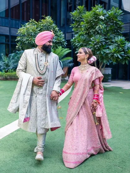 A Sikh couple walks hand-in-hand, sharing a look of love and understanding. I capture the elegance and connection of couples from all traditions.