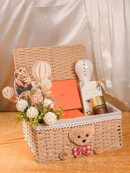 Welcoming a new baby is a precious moment, and I love creating hampers to match. This custom baby announcement basket includes a cute teddy bear, themed decor, and luxury brand gifts, all presented in a beautiful keepsake wicker basket.