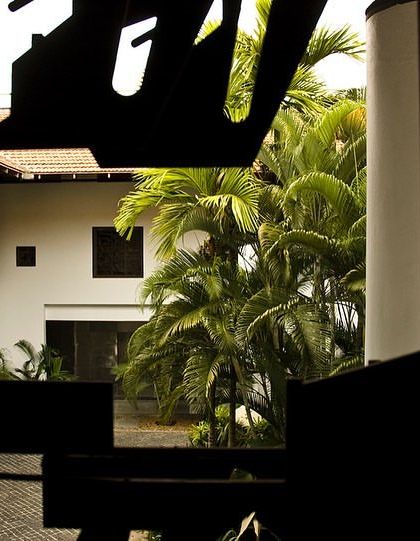 A glimpse into the LMW Headquarters courtyard, framed by the intricate silhouette of a custom-designed metal screen. This layering of views through art is a recurring theme in my work.