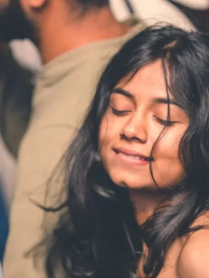 A partygoer lost in the moment, feeling the music.
