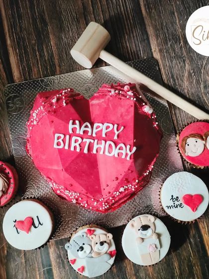 A smashable heart piñata cake is such a fun way to celebrate a birthday. This one comes with a hammer and is paired with adorable, love-themed cupcakes.
