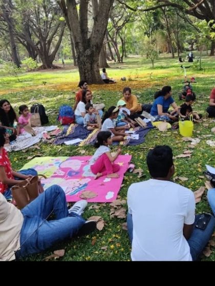 A candid shot of our community enjoying a story session in the park. These gatherings are all about creating a relaxed and welcoming space for families.