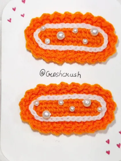 Bright orange Korean-inspired hairclips detailed with delicate white pearls.
