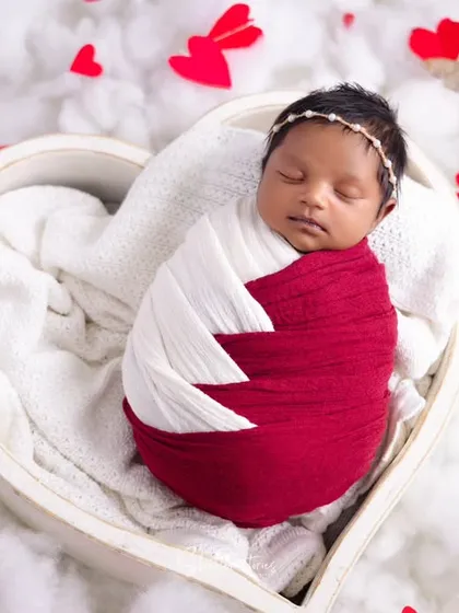 A love-themed setup perfect for a Valentine's baby. The heart-shaped bowl and red and white color palette create a sweet and celebratory image.