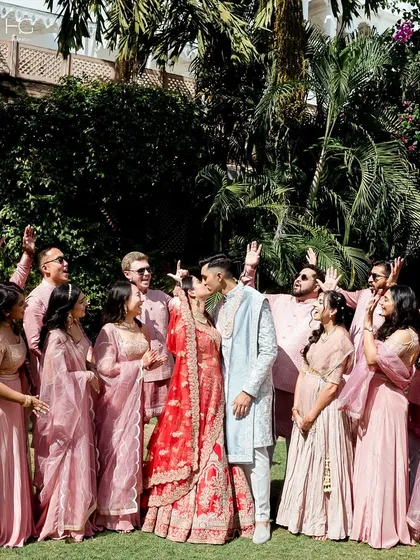 A joyous celebration with family and friends. The groom's bespoke sherwani stands out beautifully amidst the coordinated outfits of the wedding party.