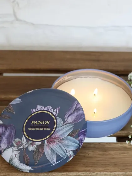 Our large three-wick scented candle in a floral tin. It’s designed to infuse your space with a subtle, layered fragrance that gently fills the room without being overwhelming.