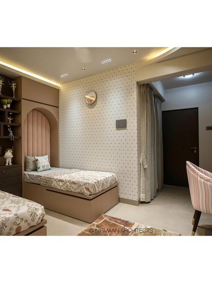 This shared bedroom for two daughters in our Duplex Project features custom beds with upholstered headboards set in arched nooks. The design creates a sense of personal space for each child.