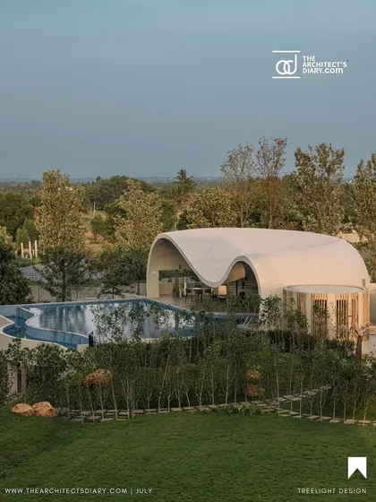 This aerial view from The Architect's Diary feature shows how the organic form of the Aqua Pool & Spa settles into the lush green landscape.