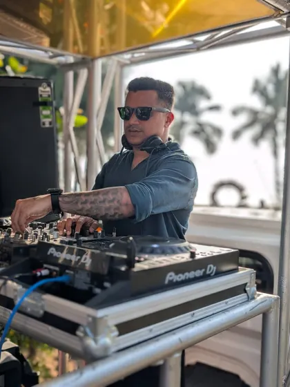 A close-up shot of me at the console during a daytime event in Goa. Even in bright sunlight, the focus is on delivering a flawless musical experience.