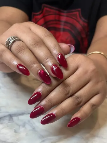 The full view of the red cat-eye nails. It's a sophisticated way to wear red, with a hidden depth that reveals itself in the light.