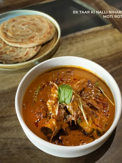 Ek Taar Ki Nalli Nihari, a rich and aromatic slow-cooked lamb shank curry. Served with flaky Moti Roti, this is a truly indulgent main course featured on our special Ramzan menu.