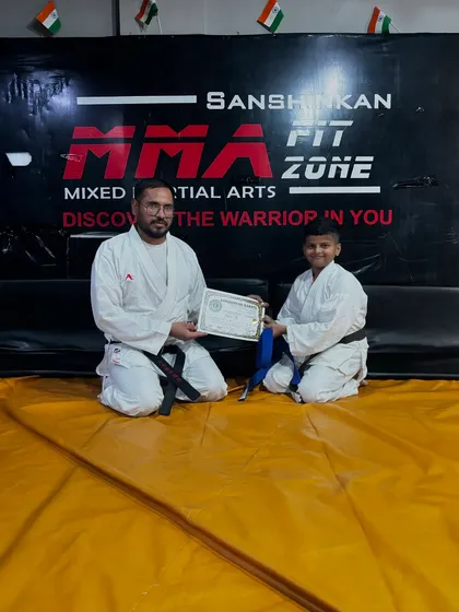 Another student leveling up, receiving his blue belt in karate. We track and celebrate every student's individual journey.