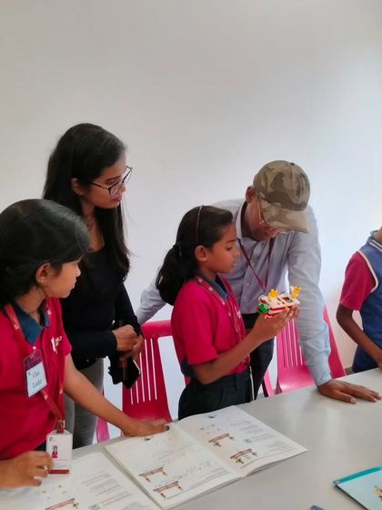 A family explores a student's project together at our showcase event at Vidyashilp Academy. These events are a great way for parents to see the practical application of STEM skills.