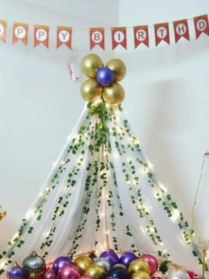 A close-up of the birthday teepee, adorned with a "Happy Birthday" banner and a floral balloon topper.