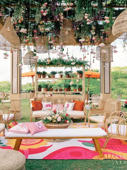 Another view of the lounge at 'Villa Brissa', showcasing the hanging rattan baskets, floral installations, and custom-printed textiles that brought the Balinese theme to life.