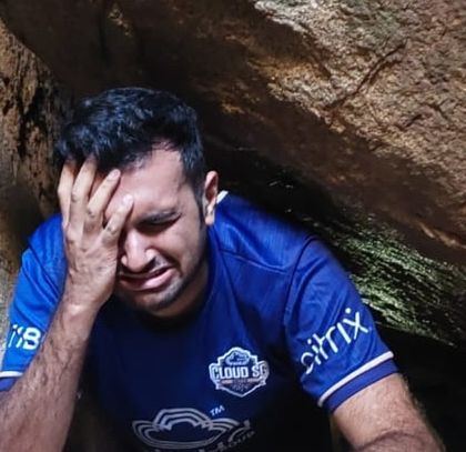 The struggle is real but fun! A trekker squeezing through a tight spot in the Anthargange caves.