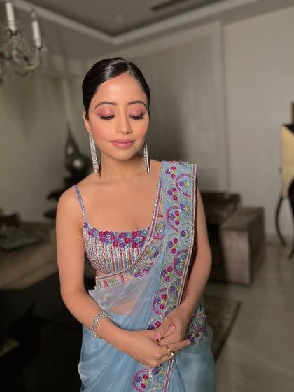 Eyes closed, this shot showcases the beautiful blend of pink eyeshadow, perfect for a soft glam party look.