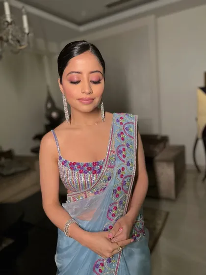Eyes closed, this shot showcases the beautiful blend of pink eyeshadow, perfect for a soft glam party look.