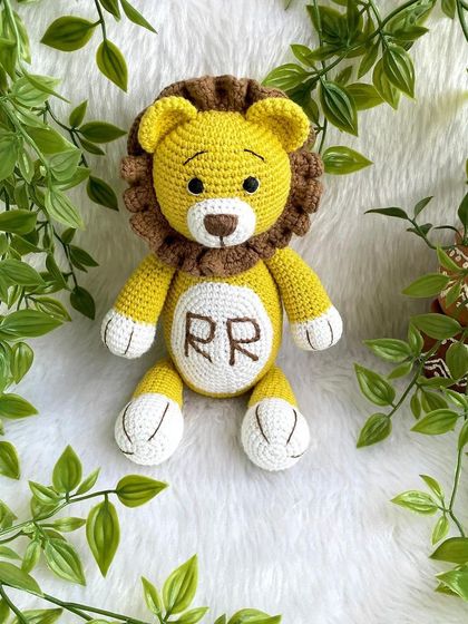 A royal lion plushie, personalized with the initials "RR" on his belly. This majestic friend is ready to rule the playroom with kindness.