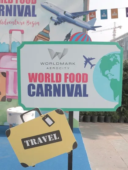 The official signage for the World Food Carnival, themed around travel and global adventure. This sets the expectation for a journey of flavors from around the world.