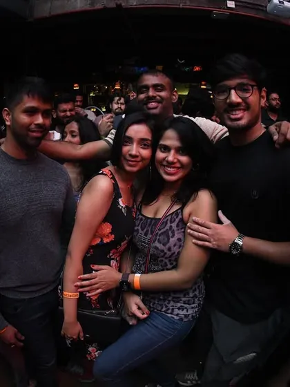 Friends posing for a group photo at the club.