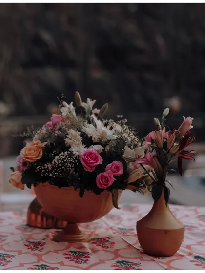 A beautiful detail shot of the floral arrangements and table decor, showcasing the elegant and romantic styling of a pre-wedding event.