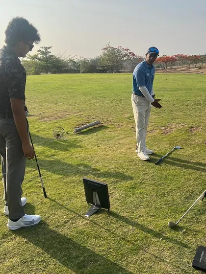 A coach demonstrates the correct follow-through position to a player. Visual learning is a powerful tool we use frequently.