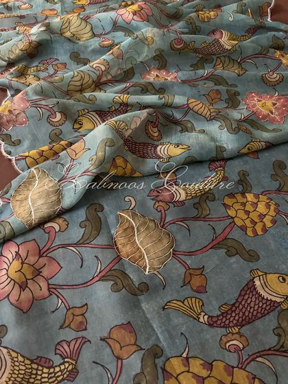 This shot displays a larger section of the dupatta, showing the repeating pattern of fish, leaves, and flowers, all hand-painted with natural dyes.