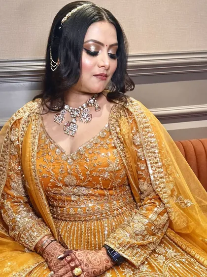A close-up of the eye makeup and delicate hair accessory. The look is both traditional and glamorous.
