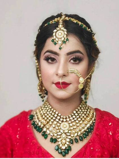 A full view of a stunning Kundan necklace with large uncut stones and emerald green drops. This piece is available for rent and I offer pan-India delivery.