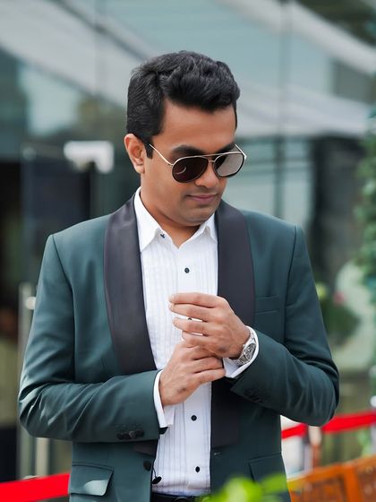 A striking deep green tuxedo with a black shawl collar. This outfit proves that kindness and sharp style can go hand-in-hand, creating a memorable look for any formal occasion.