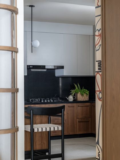 A peek into the kitchen, framed by the line-art mural.